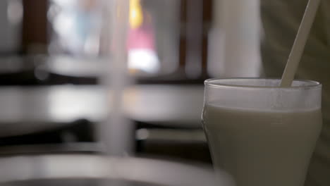 person drinking horchata in cafe