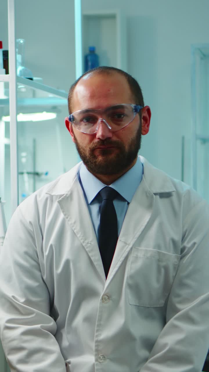 Vertical video: Portrait of exhausted chemist looking at camera