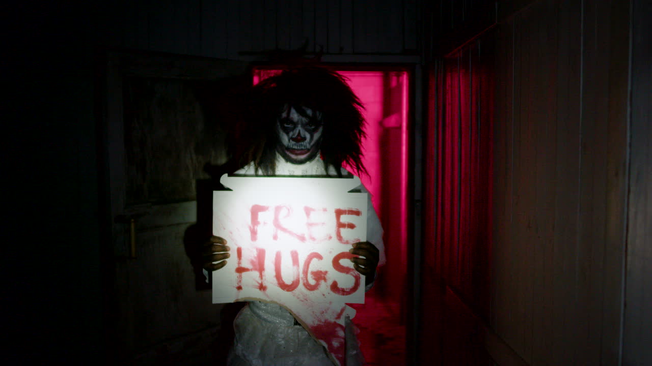 Clown holding banner