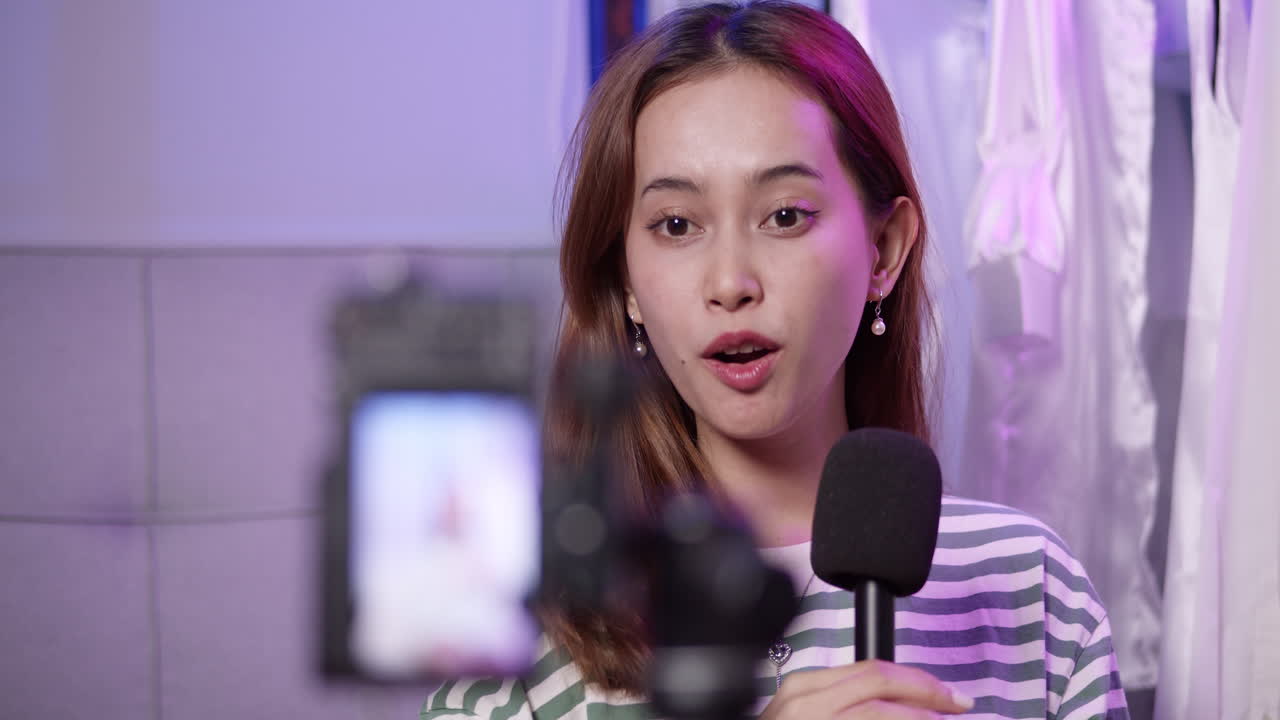 A live streaming asian girl promoting her merchandise