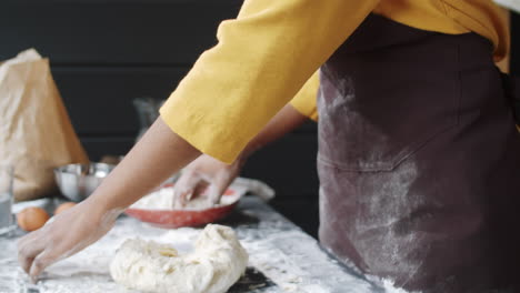 african american woman kneading dough