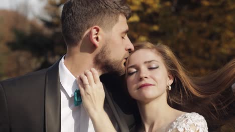 newlyweds. caucasian groom with bride in the park. wedding couple. happy family