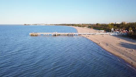 Wooden-pier-aerial-shot,-late-afternoon-light