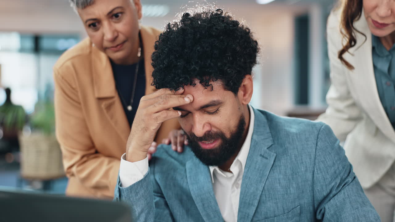 A businessman is stressed and talking with his colleagues about the project.
