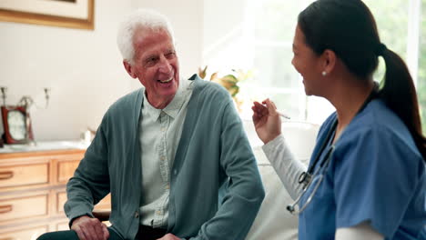 Caregiver assisting elderly man at home