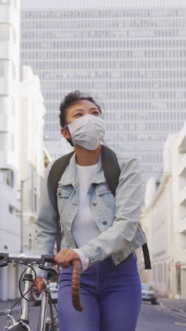 woman wearing medical coronavirus mask walking on the street