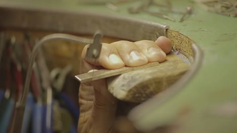 italian goldsmith at work building an engagement or a wedding ring