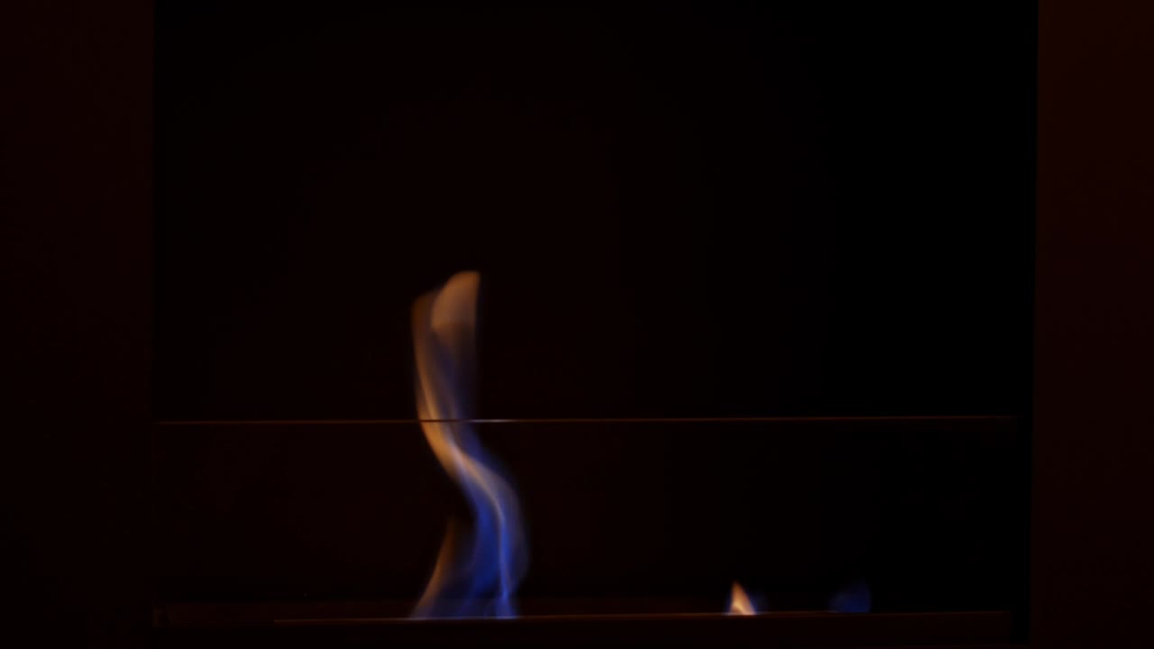 The flames burn in the home eco fireplace.