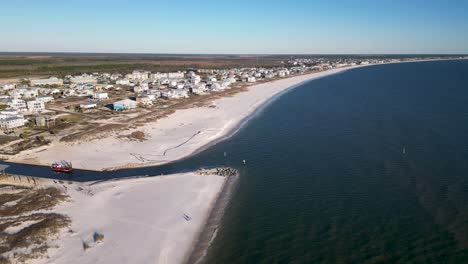 drone view from over water of mexico beach florida showing white sands and rebuilding four years after hurricane michael