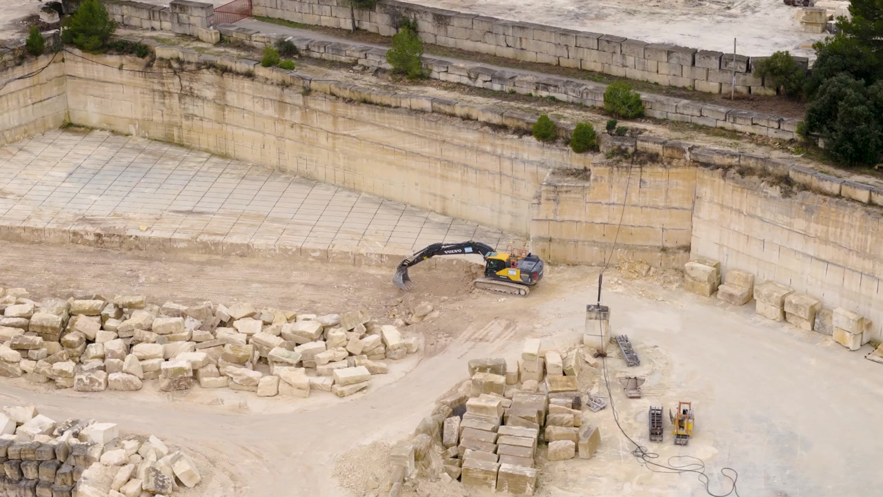 Aerial Orbit View Excavator Digging Open Pit Limestone Quarry Construction Site in Progress