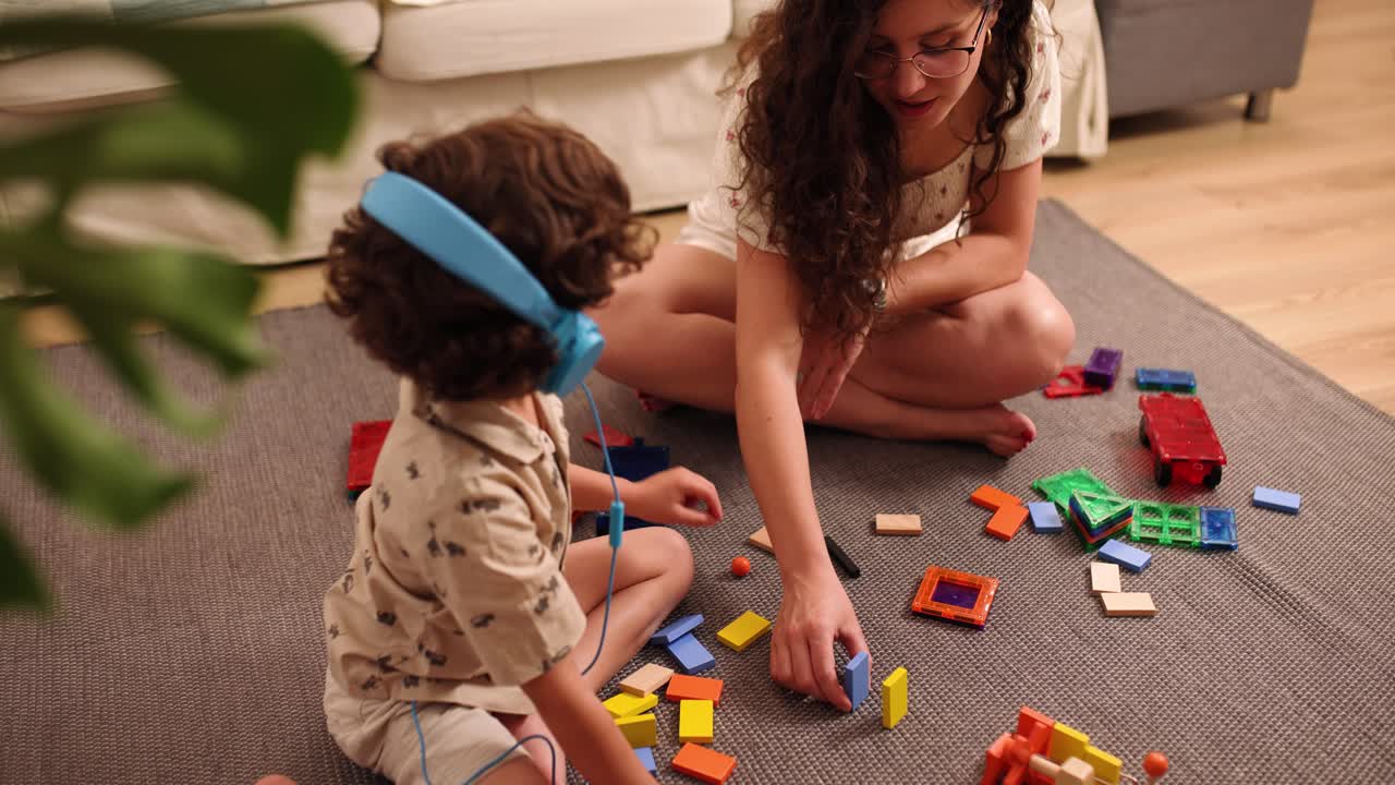 Mother and child playing with colorful building blocks