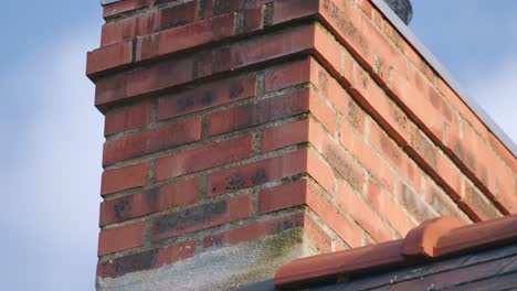 red brick chimney on the roof, closeup