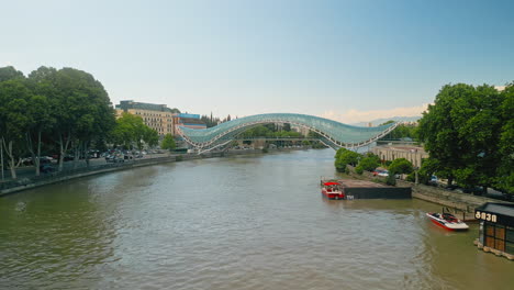 panoramic view of the bridge of peace over the mtkvari river in tbilisi, georgia