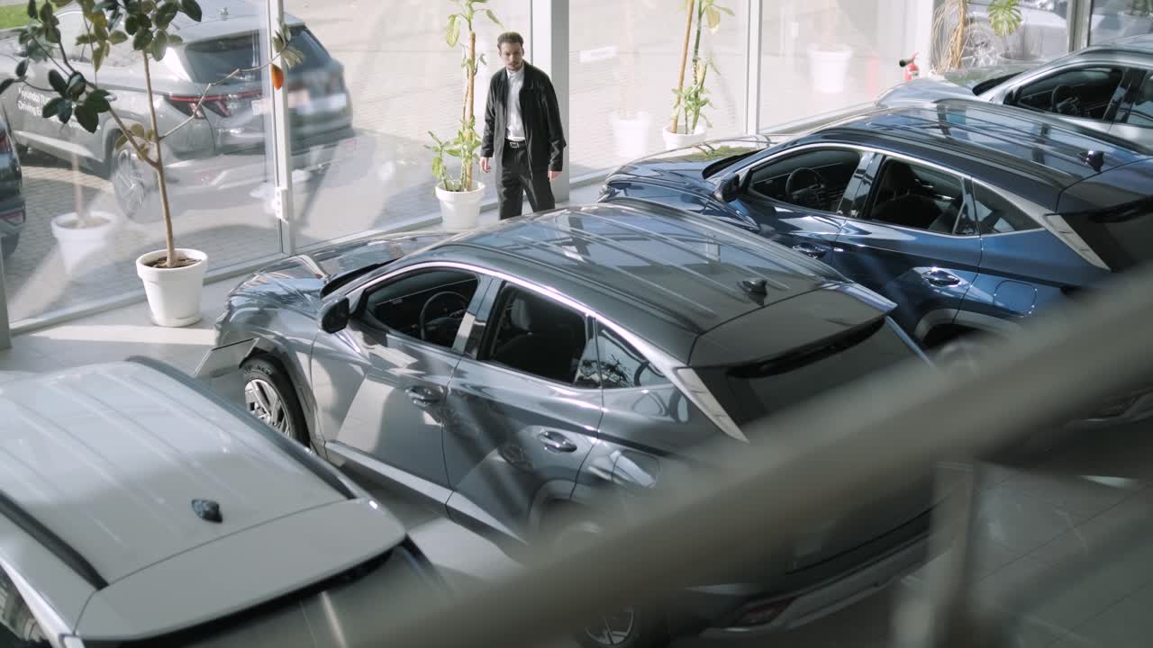 Cars in a Dealership with a Man