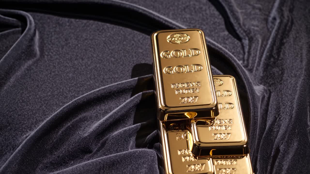 Close-up video angle of gold bars on luxurious black velvet, showcasing wealth and elegance