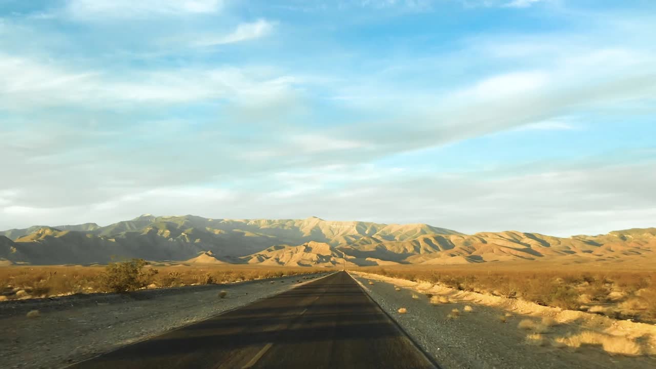 Driving down a long desert road