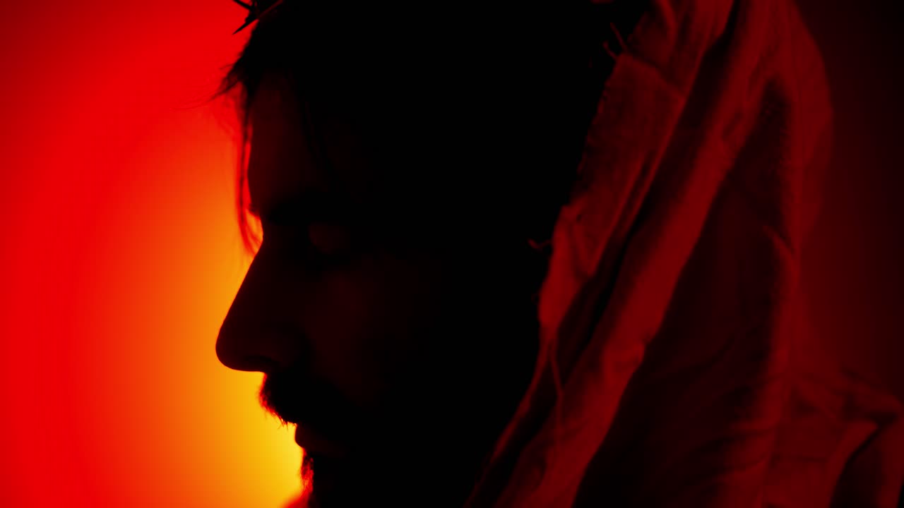 Face silhouette of Jesus Christ wearing crown of thorns for Christianity, Easter visual, bible scene or temptation, prayer, worship visual.