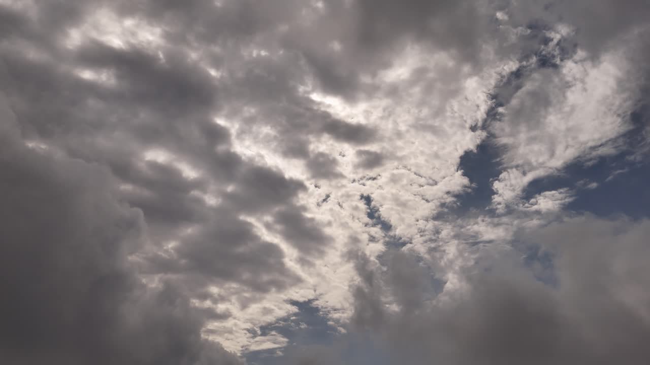 Enjoy the peaceful motion of clouds drifting across a brilliant blue sky.