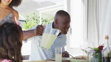 video of african american family spending time together and having dinner outside