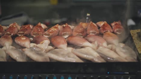 Grilling-Squid-In-A-Japanese-Food-Stall-During-Yoiyama-Festival-At-The-Gion-Matsuri-Festival-Night-In-Kyoto,-Japan---close-up