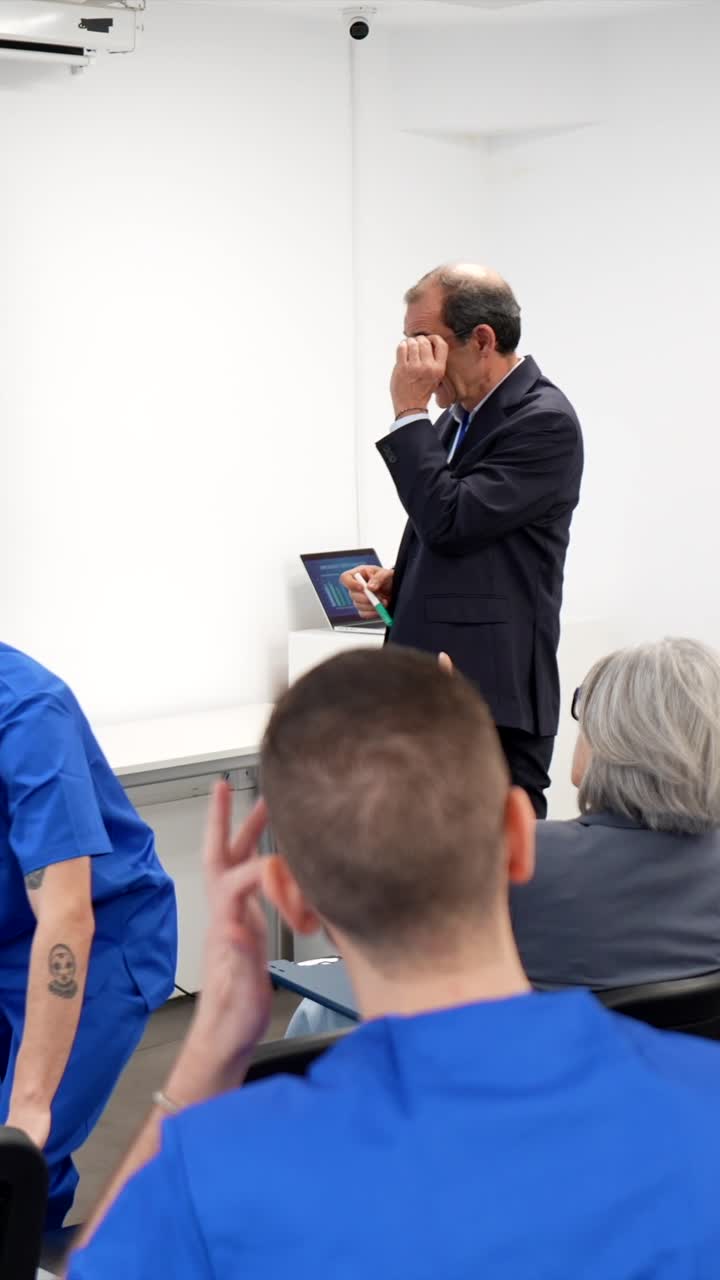 Medical Professor Explaining Oncology Data Analysis to Students