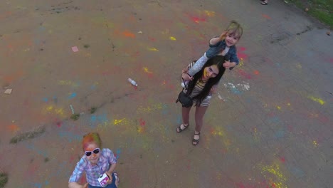 people celebrating festival of colors. vinnitsa, ukraine - july 2017: young people at holi party covered with color powder