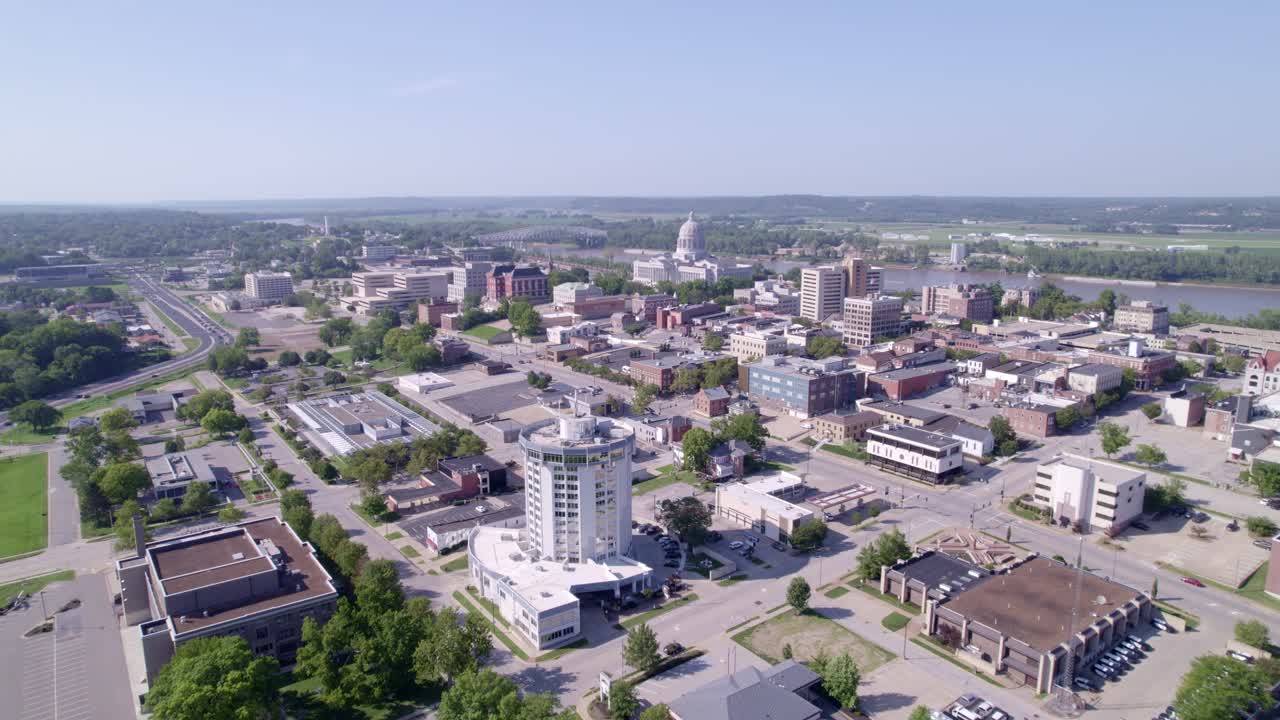 Soar through the skies over Jefferson City, showcasing the majestic Capitol building and its surroundings.