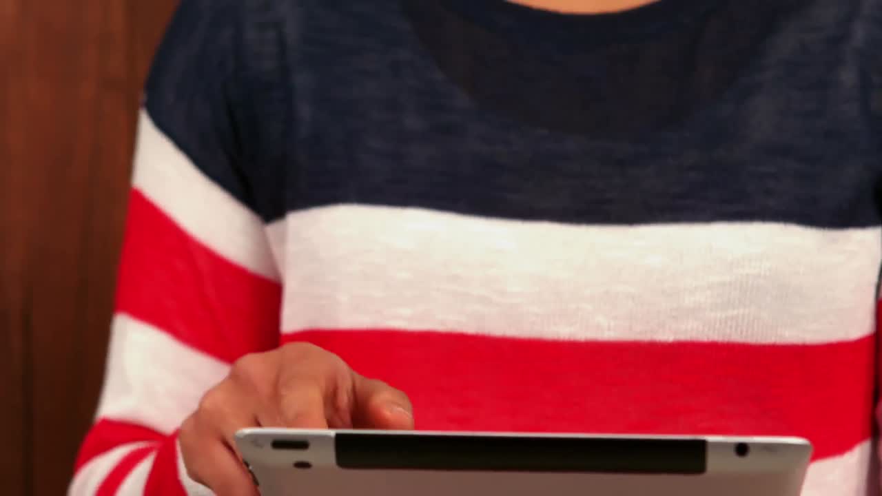 Pretty smiling hipster using tablet