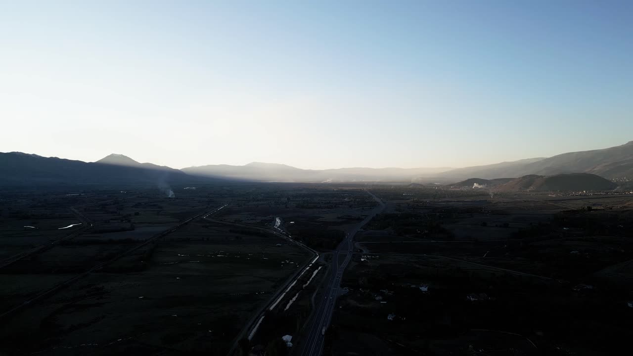 sunrise on the highway between the mountains. one side west and the other east