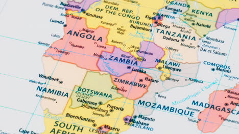 close-up of the country word zambia on a world map with the detailed name of the capital city