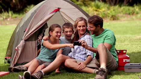 Young-family-looking-at-photos-on-their-camera