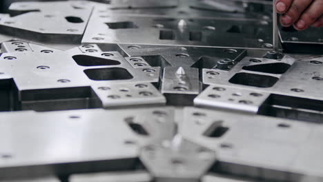 close up of a big metal shaping tool being put together after maintenance and is read for the hydraulic press in a car part production