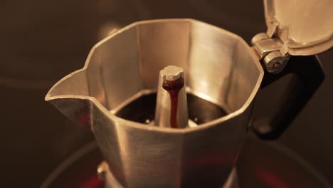 closeup of making espresso coffee in moka pot on electric cooker