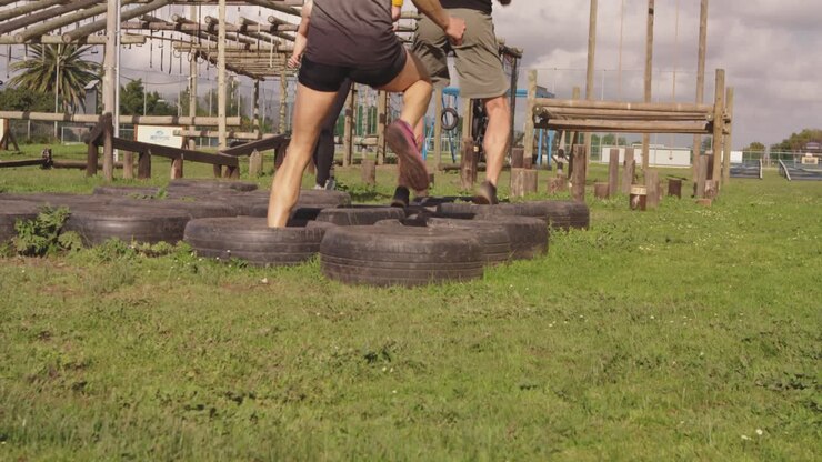 Young adults training at an outdoor gym bootcamp