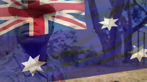 animation of flag of australia over african american male soldier