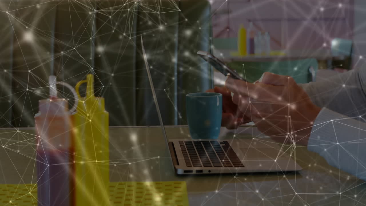 Office worker tapping smartphone at cafe table, merging laptop data with floating technology nodes