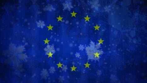 european flag with snowflakes during snowfall