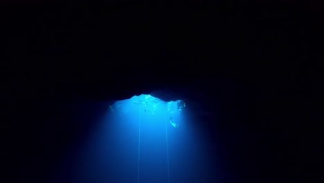 mirror reflection in a cave when a freediver escending from the surface