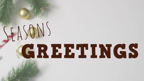 Animation-of-christmas-greetings-text-over-christmas-decorations