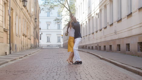 interracial couple dancing bachata in the old town street 1