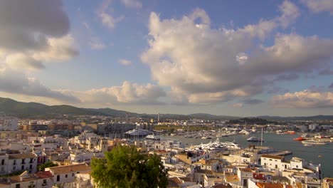 view of ibiza harbor from the top of dalt vila, boats, cruises, and the old town, during a beautiful sunny summer afternoon