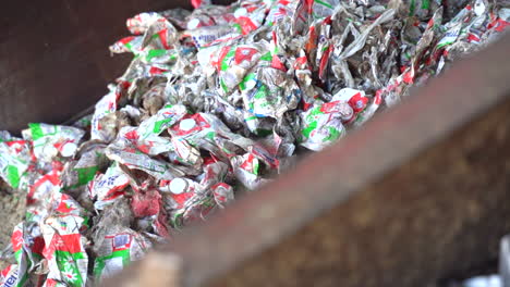 cinematic-panning-shot-of-milk-cartons-just-before-they-are-ready-for-recycling