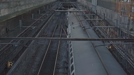 Pan-down-of-a-train-moving-slowly-on-the-railway-lines-in-the-middle-of-the-city-of-Paris-in-France