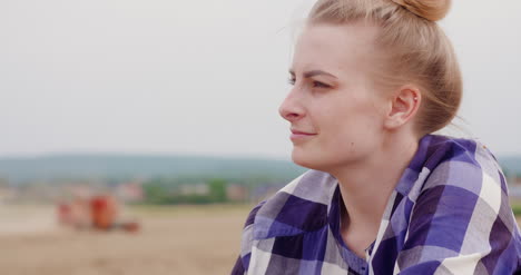 agriculture female farmer looking at crops during harvesting 2