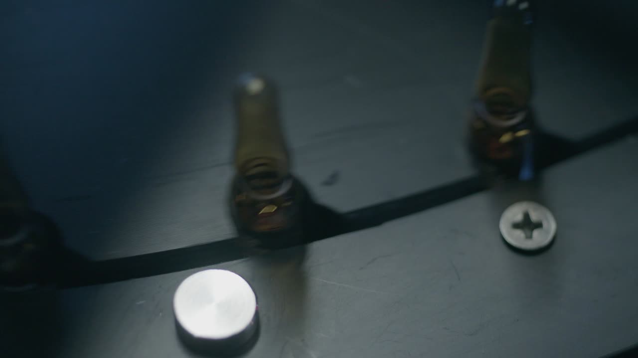 Various dark bottles with medication circulate in circular motions, ensuring efficient movement and processing