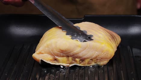 cooking fish fillet on a grill pan