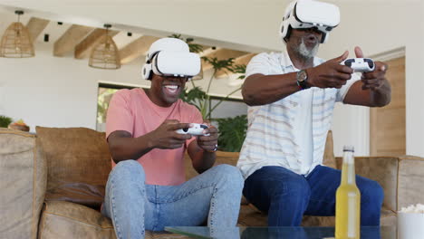 playing video games with vr headsets, father and adult son enjoying virtual reality experience