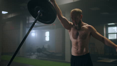 training-of-the-boxer-striking-technique.-Push-the-bar-with-one-hand.-build-up-of-force-blows-for-the-fighter.-Training-a-sporty-man.