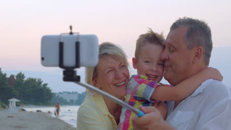 family mobile selfie with child and grandparents