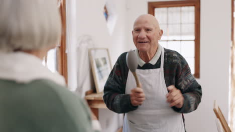 Kitchen,-singing-and-senior-couple-dance-together